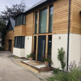 Contemporary Cladded glass property entrance with bespoke lighting by PWH Building Ltd